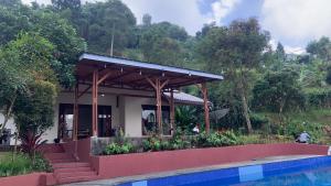 a house with a swimming pool in front of it at Villa Kay Hills in Sampal 2