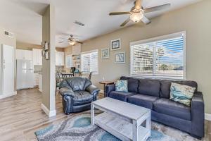 a living room with a couch and two chairs at Leeward 802 in Corpus Christi