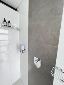 a bathroom with a shower with a glass door at Large Apartment High Views and Balcony in Medellín