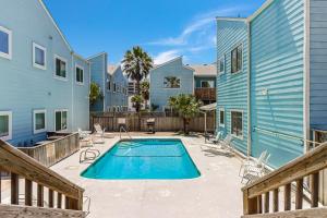 a swimming pool in a yard next to a house at Leeward 802 in Corpus Christi