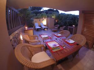 a table and chairs on a balcony with a table and chairs at Luxury Apartment Sardegna in Marina di Portisco