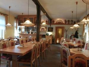a dining room with tables and chairs in a restaurant at Helenenhof in Kurort Altenberg +56 photos
