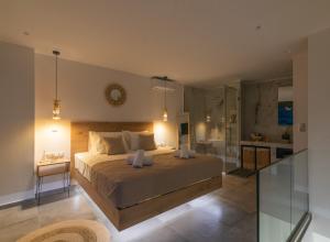 a bedroom with a large bed and a bathroom at Aphrodite Luxury Accommodation in Matala