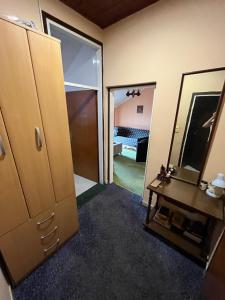 a room with a closet and a mirror and a table at Korra in Herceg-Novi