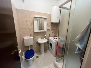 a small bathroom with a toilet and a sink at Korra in Herceg-Novi +3 photos