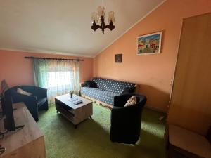 a living room with a couch and chairs at Korra in Herceg-Novi