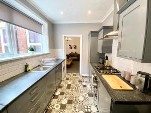 a kitchen with a sink and a counter top at 3 Queen Alexandra Road in North Shields