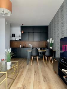 cocina con mesa y sillas en una habitación en Apartament Drewnowska przy Manufakturze en Lodz