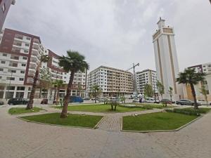 a park with a clock tower in a city at Magnifique Appartement Golf Tanger for Families in Tangier