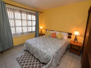 a bedroom with a bed and a large window at La Hacienda San Felipe Condo 10 in San Felipe +17 photos