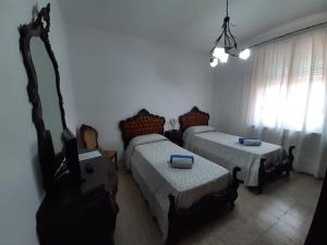 a room with two beds and a television in it at LOCAZIONE TURISTICA ANNA in Porto Viro