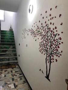 a tree with leaves on a wall with stairs at Il melograno in Usini
