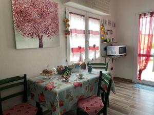 a table in a kitchen with a table cloth on it at Il melograno in Usini