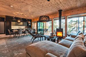 - un salon avec un canapé et une cheminée dans l'établissement Saunamäki Resort - State of the Art Coastal Villa, à Salo