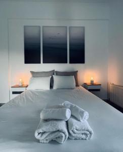 a bedroom with a bed with towels on it at Villa Rodanthi Sivota in Syvota