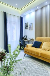 a living room with a yellow couch and a table at RINO LUXURY ROOM in Zadar