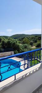 a swimming pool on the balcony of a house at Villa Rodanthi Sivota in Syvota