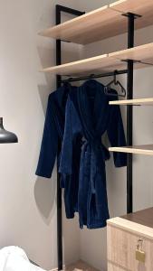 a blue shirt is hanging in a closet at شاليهات بلاسيو 