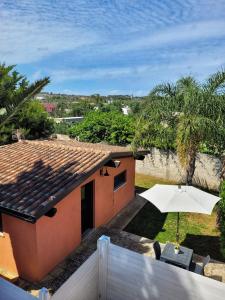 a view from the roof of a house with an umbrella at Gallipoli lato sudChalet Pesco in Taviano