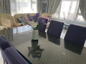 a table with a vase of flowers on top of it at The Bungalow Castlepollard in Westmeath