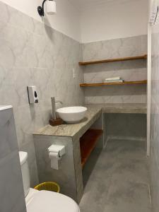 a bathroom with a sink and a toilet at Summer Beach Paje in Paje
