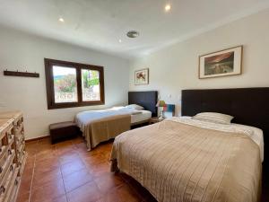 a hotel room with two beds and a window at Villa Buena Vista in Palmanova +52 photos