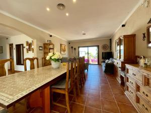 a kitchen and dining room with a table and chairs at Villa Buena Vista in Palmanova +52 photos