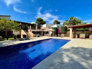 a swimming pool in front of a house at Villa Buena Vista in Palmanova