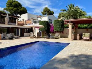 a villa with a swimming pool and a house at Villa Buena Vista in Palmanova