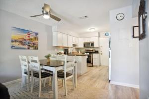 a kitchen and dining room with a table and chairs at 5 stars Peaceful Condo - 7 min walk to the beach in Hilton Head Island