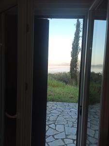 an open door to a patio with a view at Blondie's House in Evropoúloi