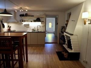 a kitchen with a table and a kitchen with a fireplace at Apartment with Terrace in the Swedish High Coast in Docksta