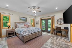 a bedroom with a bed and a desk and a ceiling fan at Stunning Views, Superb Atmosphere, Modern Amenities, In the Middle of Nature in Bryson City