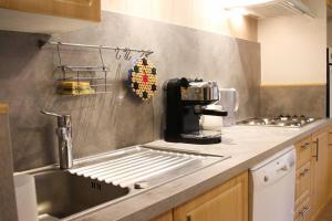 a kitchen with a sink and a counter top at L'Écrin - Appartement au pied des pistes in Orcières +7 photos
