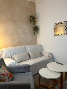 a living room with a couch and two tables at Apartamento en el casco histórico in Tarifa