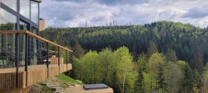 a balcony of a house with a view of a forest at Widokownia Brenna in Brenna