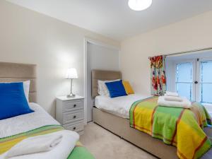 a bedroom with two beds and a window at Campbells Close Apartment in Edinburgh