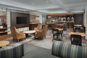 a restaurant with tables and chairs and a bar at Courtyard by Marriott Dayton Beavercreek in Beavercreek