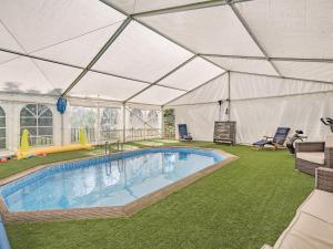 a large tent with a swimming pool in a yard at The Tranquil Orchard - Nuthatch-uk32791 in Mouswald
