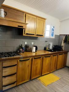 a kitchen with wooden cabinets and a stove at Ti kaz cannelle in Saint-Louis