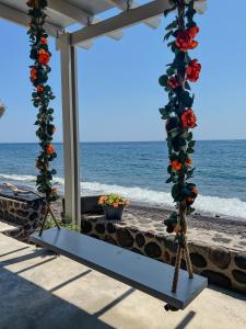 a display of flowers on a stand on the beach at BLACK BAY CAVES SUITES in Akrotiri