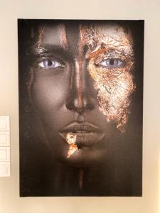 a painting of a black woman with a face at Porto Pireo Penthouse Sea View in Piraeus