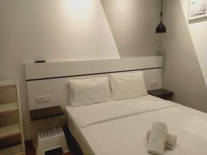 a small bedroom with a bed with white sheets and pillows at Best dreams KLtaragon residence in Kuala Lumpur