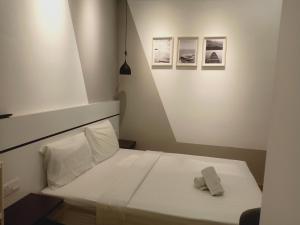 a small bedroom with a white bed with two pillows at Best dreams KLtaragon residence in Kuala Lumpur