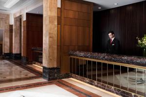 a man in a suit is standing in a lobby at Brisbane Marriott Hotel in Brisbane