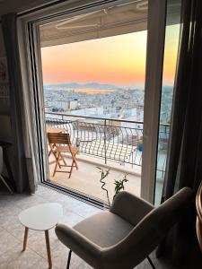 a living room with a window view of a city at Porto Pireo Penthouse Sea View in Piraeus