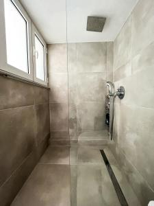 a bathroom with a shower with a glass door at Porto Pireo Penthouse Sea View in Piraeus