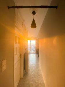 a hallway with a room with a door and a light at Porto Pireo Penthouse Sea View in Piraeus