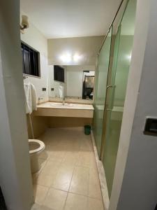 a bathroom with a toilet and a sink and a shower at Dream Inn Guest House in Islamabad