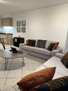 a living room with a couch and a table at Canal View One Bedroom Flat in Brussels